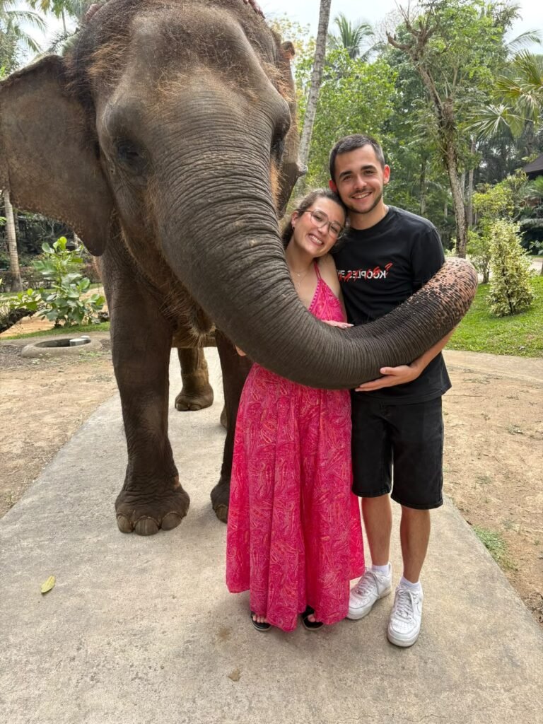 Guests walking alongside an elephant at Mason Elephant Park in Bali